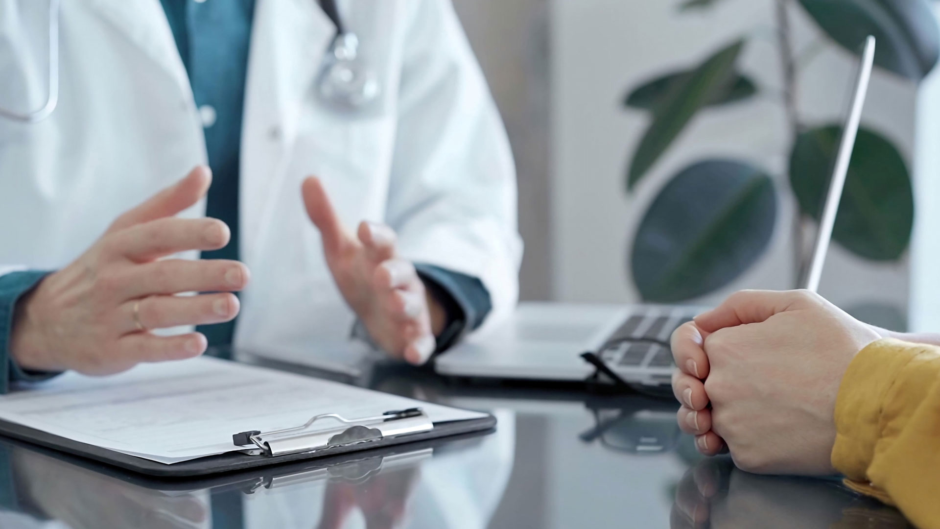 Close up of a doctor and patient consultation in clinic.