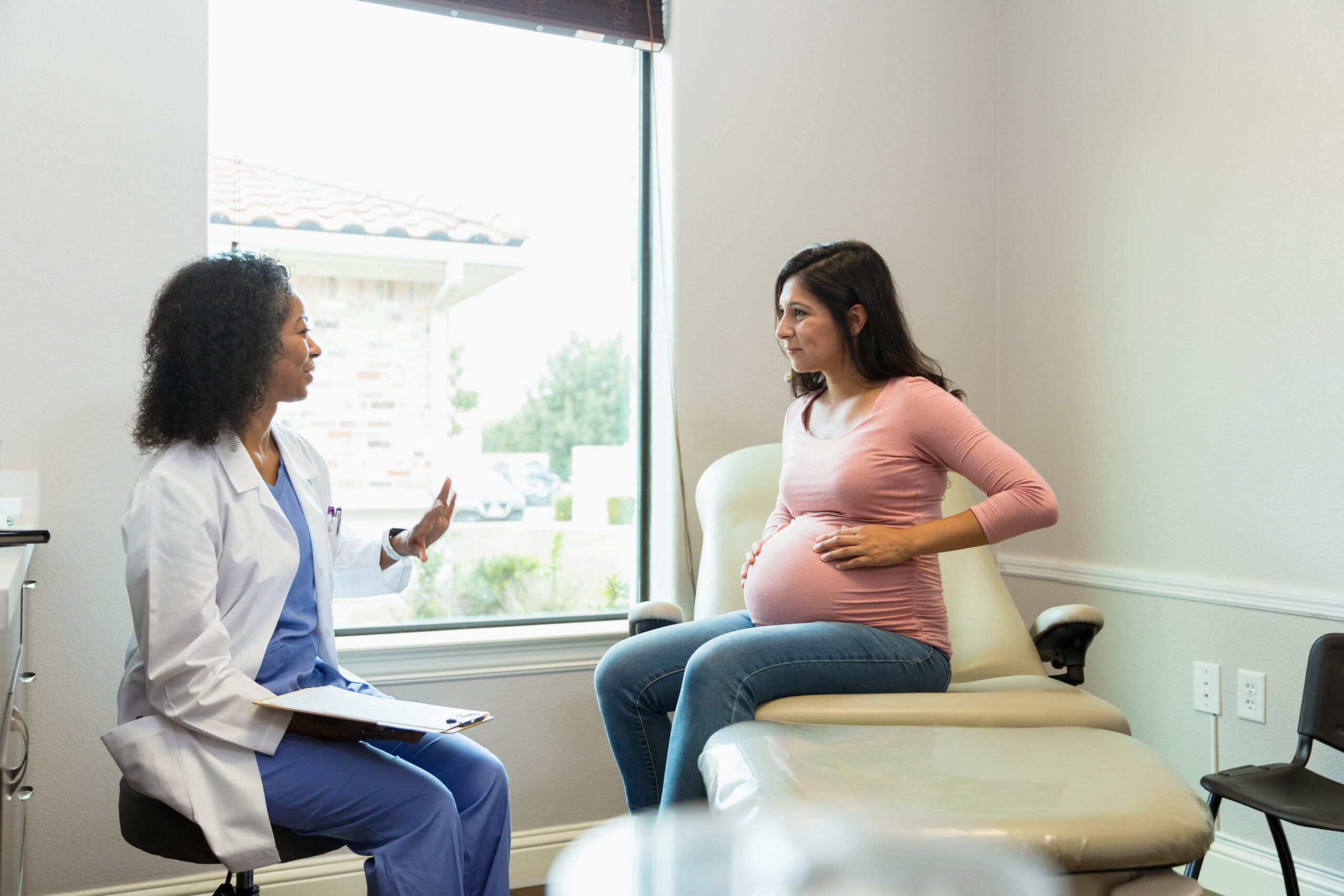 Female obstetrician talking to a pregnant patient